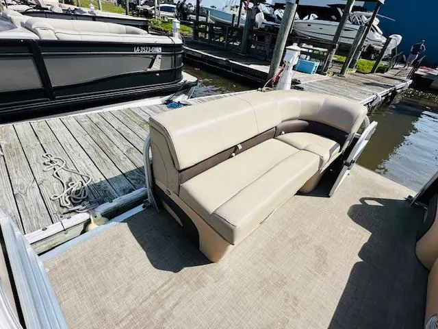 Slide: The Image of 2019 Sun Tracker Party Barge 20 DLX pontoon boat with beige seating at dock. - 11