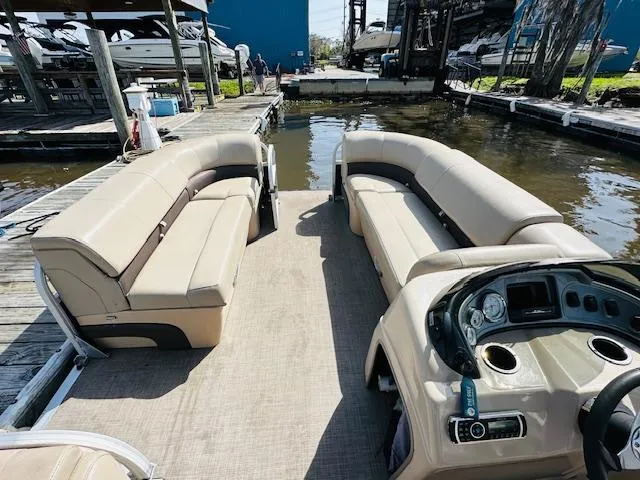 Slide: The Image of 2019 Sun Tracker Party Barge 20 DLX pontoon boat interior with beige seating and control panel. - 12