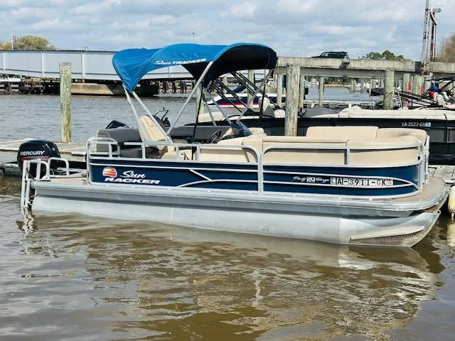 Slide: The Image of 2019 Sun Tracker Party Barge 20 DLX pontoon boat docked on a calm river. - 15