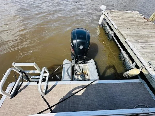 Slide: The Image of 2019 Sun Tracker Party Barge 20 DLX docked with outboard motor visible. - 5