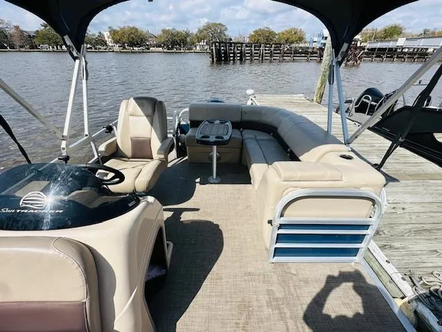 Slide: The Image of 2019 Sun Tracker Party Barge 20 DLX pontoon boat docked by a scenic river. - 6