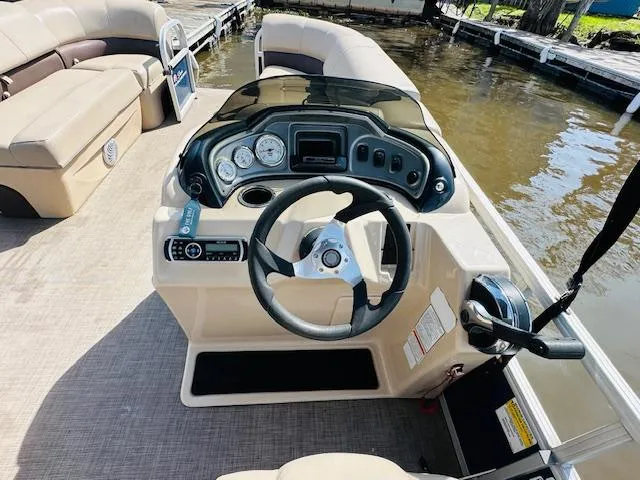 Slide: The Image of 2019 Sun Tracker Party Barge 20 DLX pontoon boat helm with steering wheel and controls. - 9
