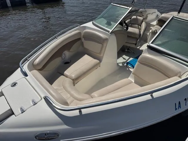 Slide: The Image of 2007 Chaparral 204SSI boat with beige seating, docked on calm water. - 4