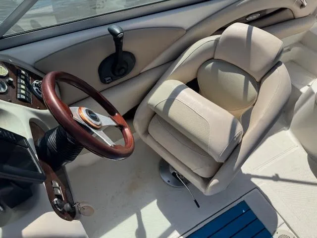 Slide: The Image of 2007 Chaparral 204SSI boat interior with steering wheel and beige seating. - 7