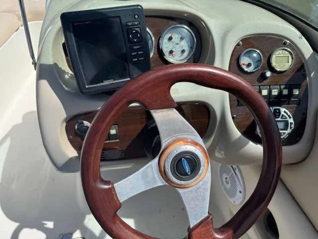 Slide: The Image of 2007 Chaparral 204SSI boat dashboard with wood steering wheel and instrument panel. - 8