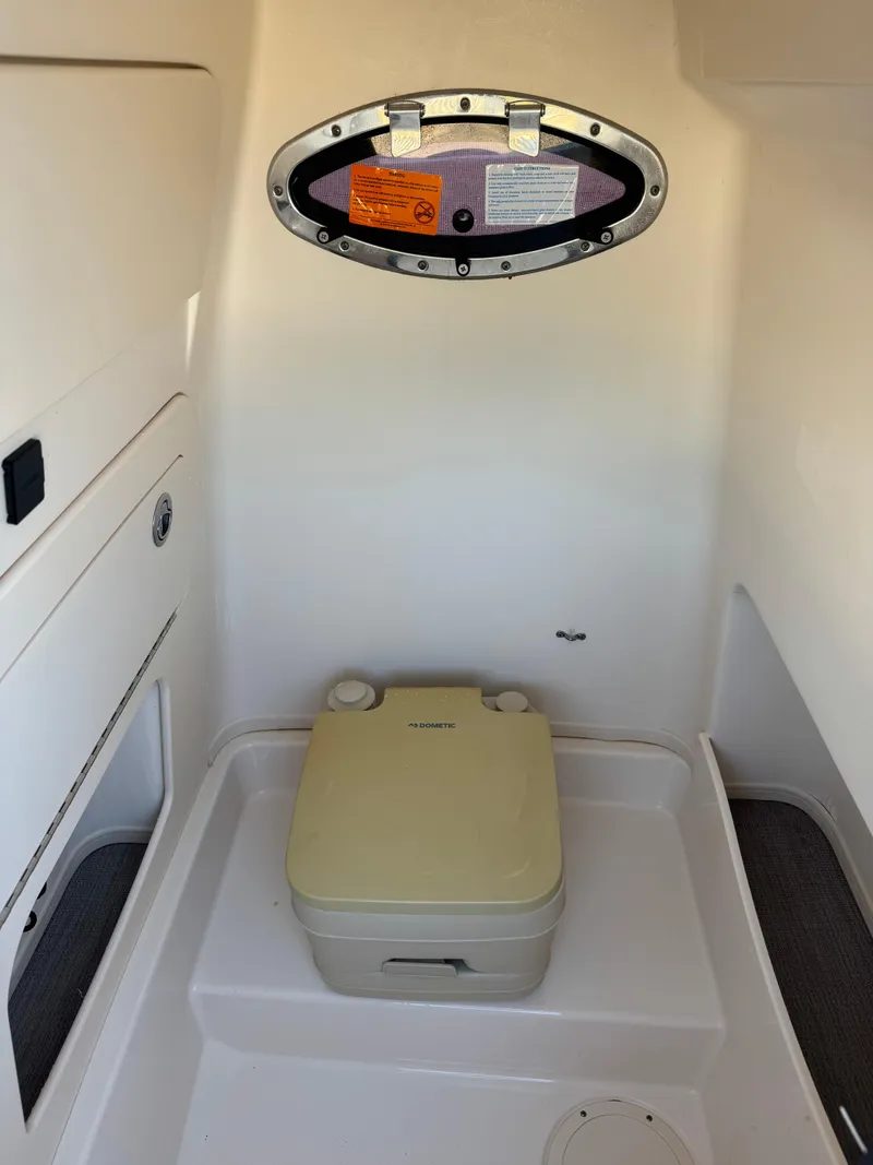 Slide: The Image of 2019 Grady-White 251 Coastal Explorer boat interior with portable toilet. - 1