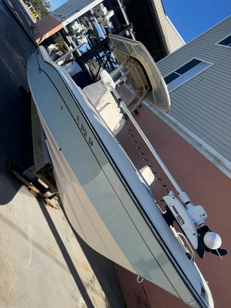 Slide: The Image of 2019 Grady-White 251 Coastal Explorer boat docked near a building. - 23