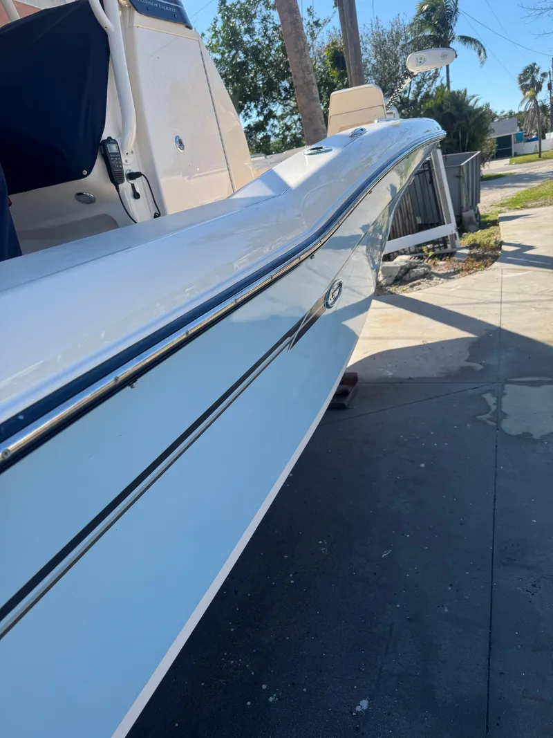 Slide: The Image of 2019 Grady-White 251 Coastal Explorer boat, sleek design, parked outdoors. - 3