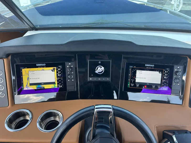Slide: The Image of Dashboard of 2023 Chaparral 300 OSX boat with dual Simrad displays. - 11