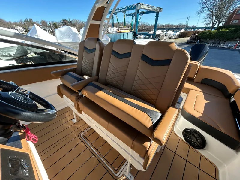 Slide: The Image of 2023 Chaparral 300 OSX boat interior with tan leather seating and modern design. - 12