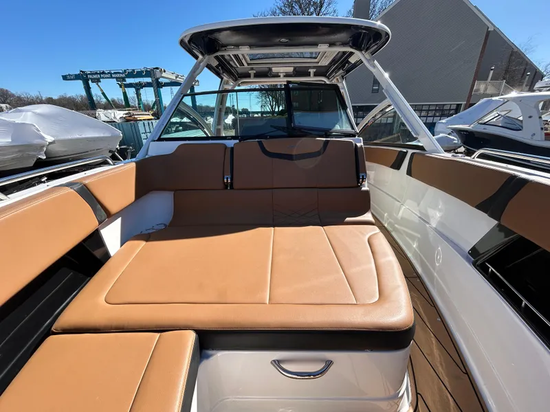 Slide: The Image of 2023 Chaparral 300 OSX boat interior with tan seating and sleek design. - 16