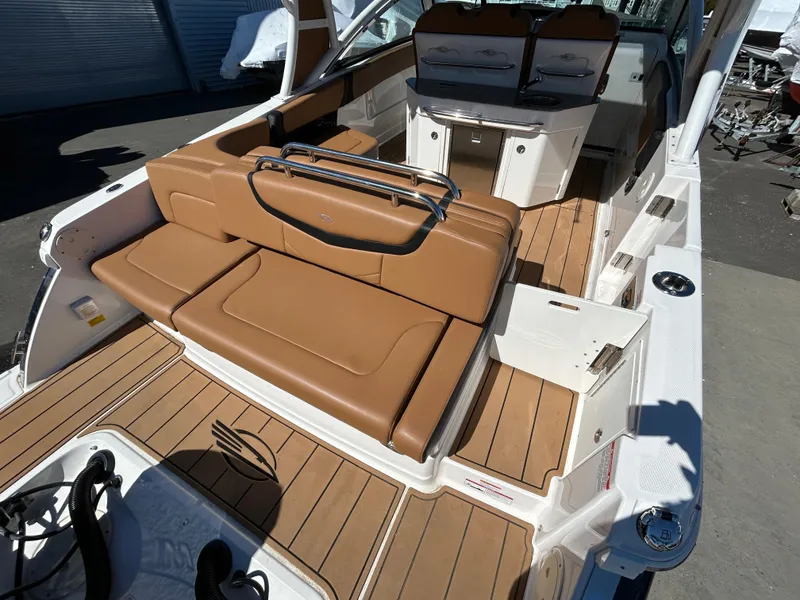 Slide: The Image of 2023 Chaparral 300 OSX boat interior with tan leather seating and sleek design. - 4