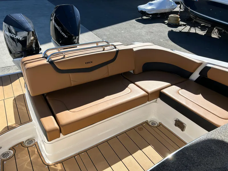 Slide: The Image of 2023 Chaparral 300 OSX boat with tan leather seating and dual Mercury engines. - 6