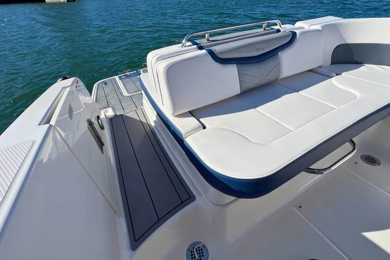 Slide: The Image of 2021 Chaparral 307 SSX boat with luxurious white seating and sleek deck design. - 11