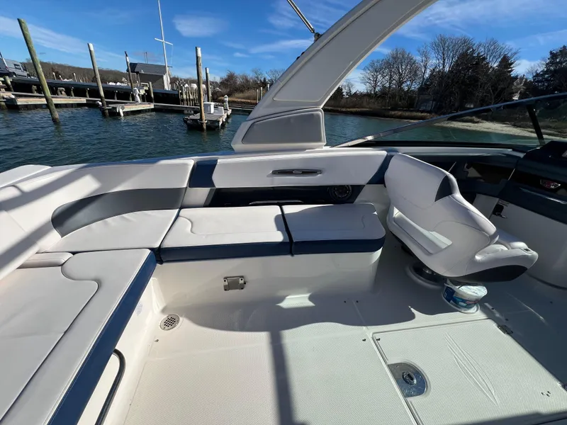 Slide: The Image of 2021 Chaparral 307 SSX boat interior with white seating and water view. - 14