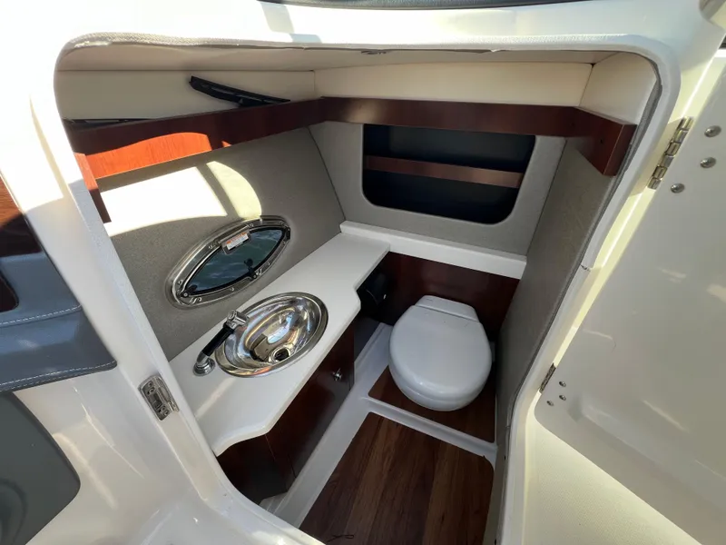 Slide: The Image of 2021 Chaparral 307 SSX boat interior with sink and toilet. - 16