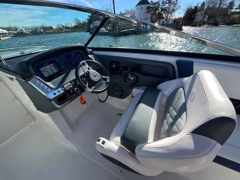 Slide: The Image of 2021 Chaparral 307 SSX boat cockpit with steering wheel and navigation displays. - 17