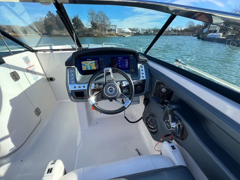 Slide: The Image of 2021 Chaparral 307 SSX boat cockpit with modern steering and navigation displays. - 18