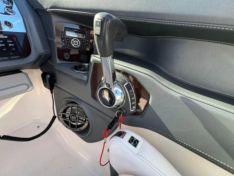 Slide: The Image of 2021 Chaparral 307 SSX boat interior, featuring control panel and throttle lever. - 20