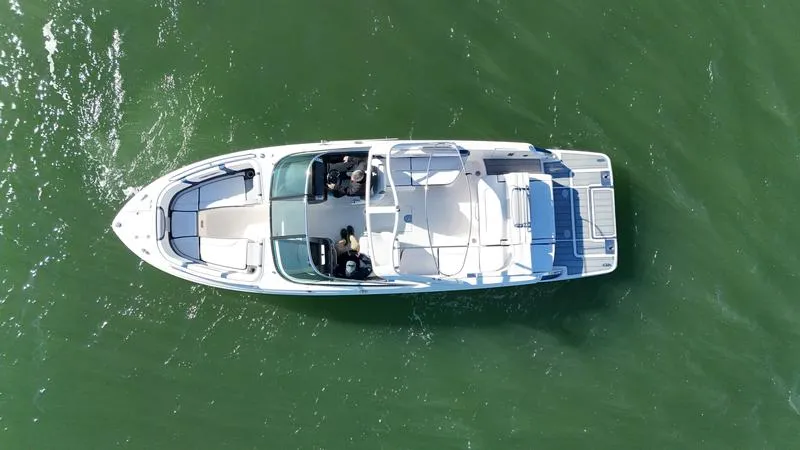 Slide: The Image of Aerial view of 2021 Chaparral 307 SSX boat on green water. - 8