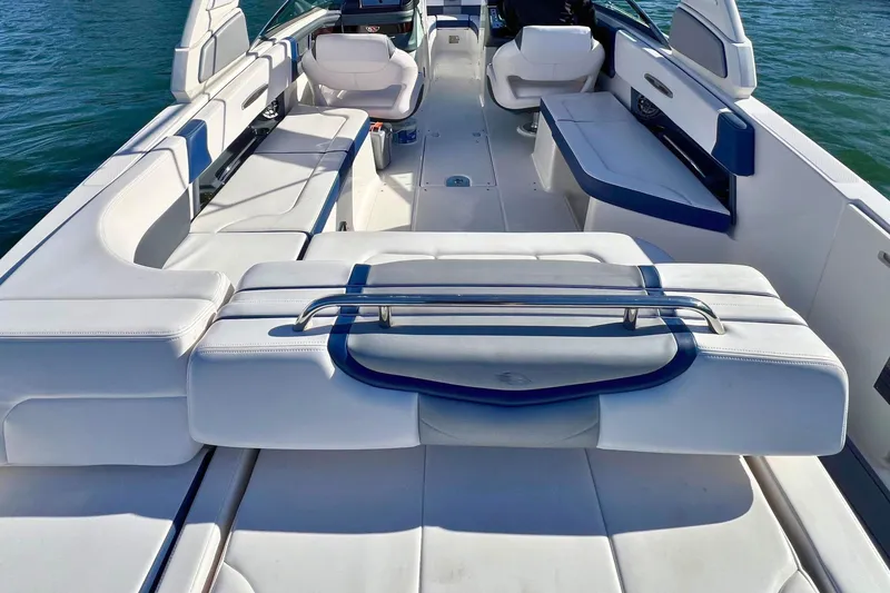 Slide: The Image of 2021 Chaparral 307 SSX boat interior with white seating and sleek design. - 9