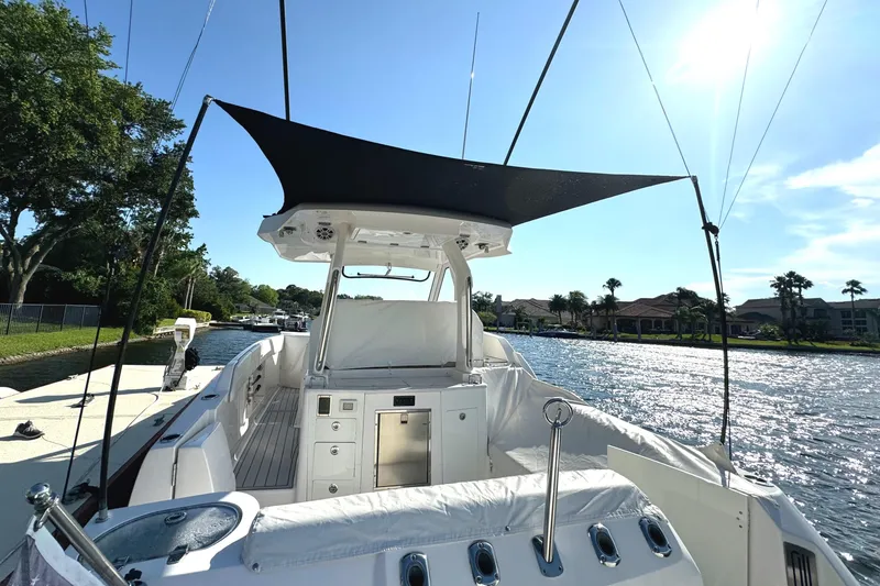 Slide: The Image of 2020 Regal 33 SAV boat with canopy on a sunny river. - 16