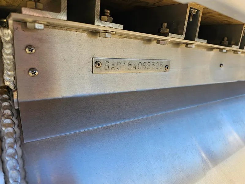 Slide: The Image of Close-up of 2025 Bentley Pontoons LEGACY 243 QUAD SWINGBACK metal component with serial number. - 27