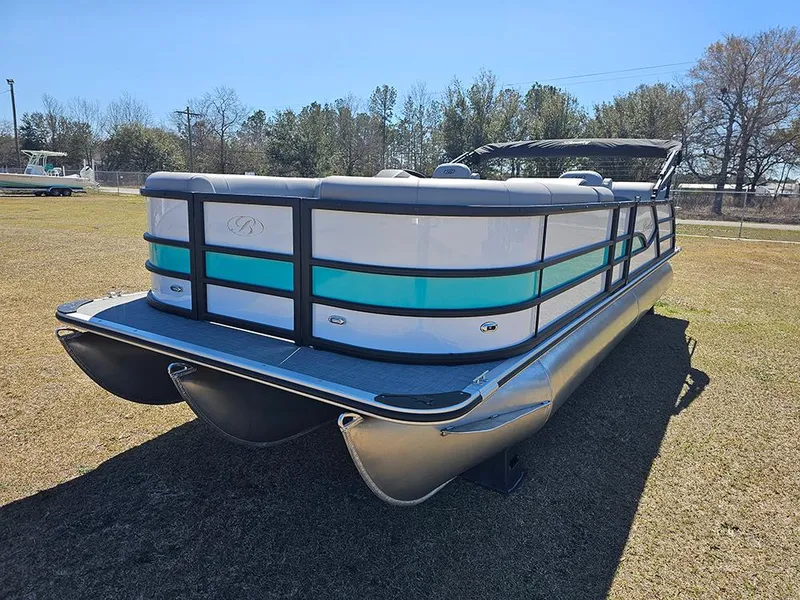 Slide: The Image of 2025 Bentley Pontoons LEGACY 243 QUAD SWINGBACK on grassy field, side view. - 5
