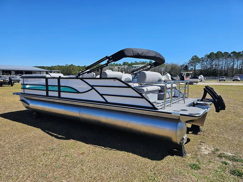Slide: The Image of 2025 Bentley Pontoons LEGACY 243 QUAD SWINGBACK on grass, featuring sleek design and comfortable seating. - 7