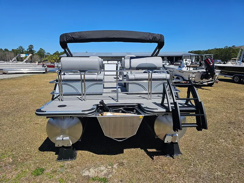 Slide: The Image of 2025 Bentley Pontoons LEGACY 243 QUAD SWINGBACK on display, rear view, outdoor setting. - 8
