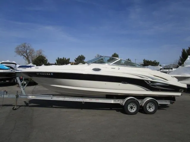 The Image of 2004 Sea Ray 270 Sundeck boat on trailer under clear blue sky. - 1