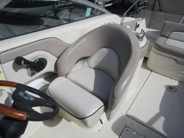 Slide: The Image of 2004 Sea Ray 270 Sundeck boat interior with steering wheel and seating. - 10