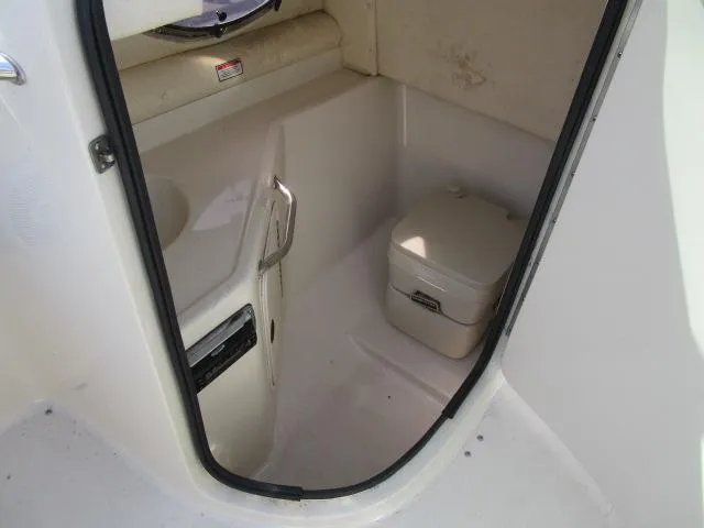 Slide: The Image of 2004 Sea Ray 270 Sundeck interior with compact marine toilet. - 14