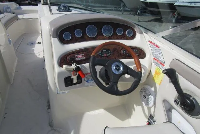 Slide: The Image of 2004 Sea Ray 270 Sundeck boat dashboard with steering wheel and instrument panel. - 21