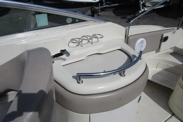 Slide: The Image of 2004 Sea Ray 270 Sundeck boat interior with cup holders and seating area. - 22
