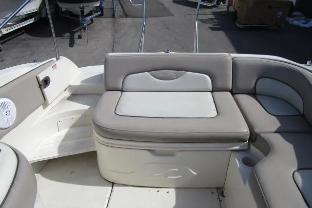Slide: The Image of 2004 Sea Ray 270 Sundeck boat interior with beige seating and storage compartments. - 23