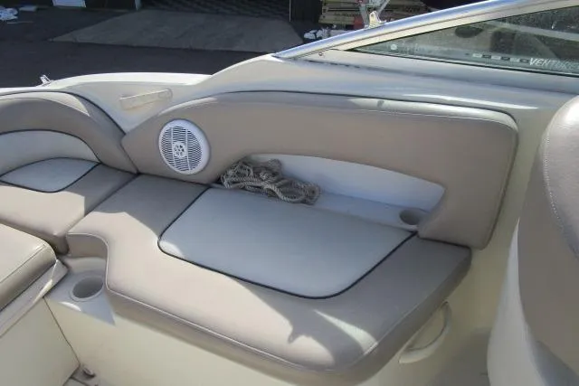 Slide: The Image of Interior seating of a 2004 Sea Ray 270 Sundeck boat with speaker and storage. - 24