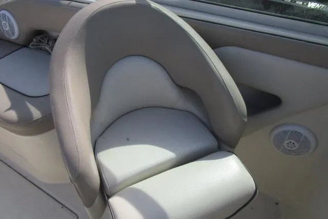 Slide: The Image of 2004 Sea Ray 270 Sundeck boat interior with cushioned seating and speaker. - 25