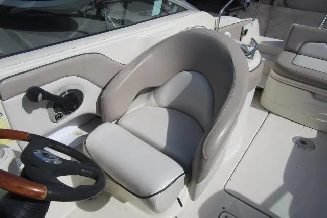 Slide: The Image of 2004 Sea Ray 270 Sundeck boat interior with steering wheel and seating area. - 26