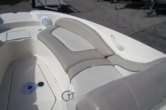 Slide: The Image of 2004 Sea Ray 270 Sundeck interior seating with beige upholstery and speaker. - 27
