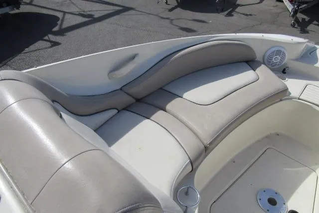 Slide: The Image of 2004 Sea Ray 270 Sundeck boat interior with cushioned seating and cup holder. - 28