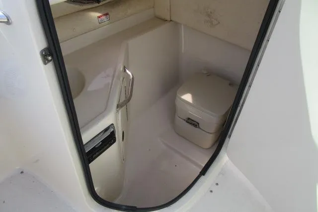 Slide: The Image of 2004 Sea Ray 270 Sundeck interior with compact marine toilet. - 30