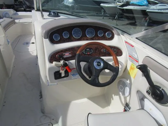 Slide: The Image of 2004 Sea Ray 270 Sundeck boat dashboard with steering wheel and instrument panel. - 5