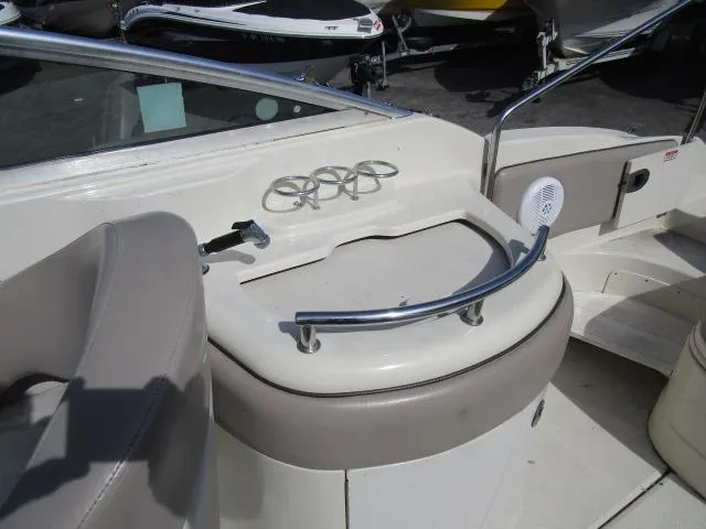 Slide: The Image of 2004 Sea Ray 270 Sundeck interior with cup holders and seating area. - 6