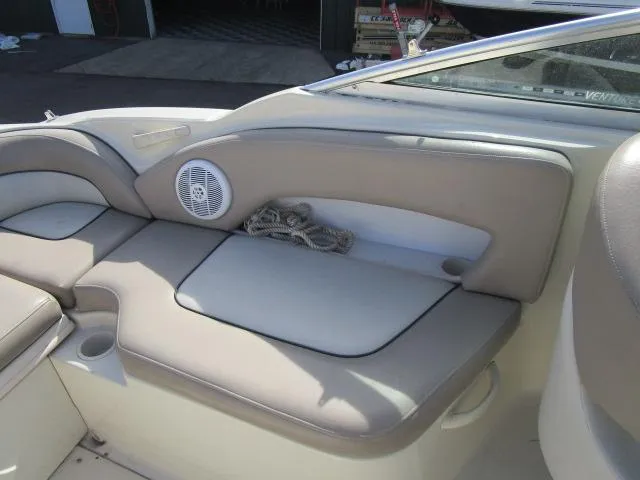 Slide: The Image of Interior seating of a 2004 Sea Ray 270 Sundeck boat with speaker and storage. - 8
