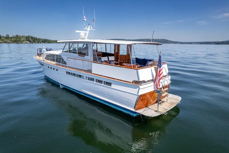 Slide: The Image of 1965 Chris-Craft 57 Constellation yacht on calm water, showcasing classic design and elegance. - 11