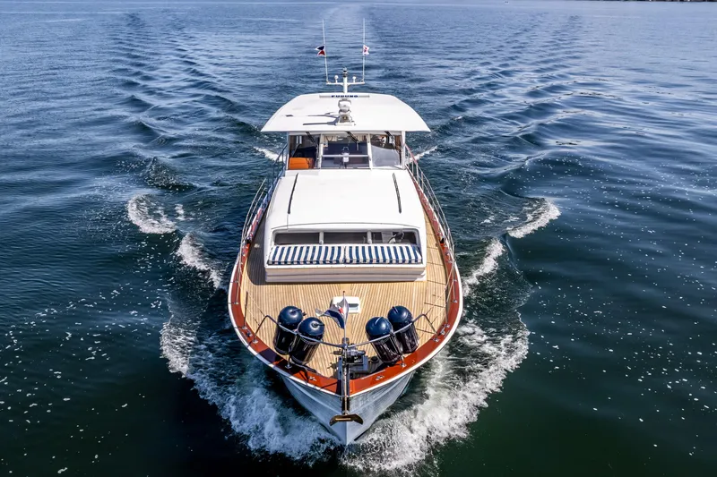 Slide: The Image of 1965 Chris-Craft 57 Constellation yacht cruising on open water, aerial view. - 12
