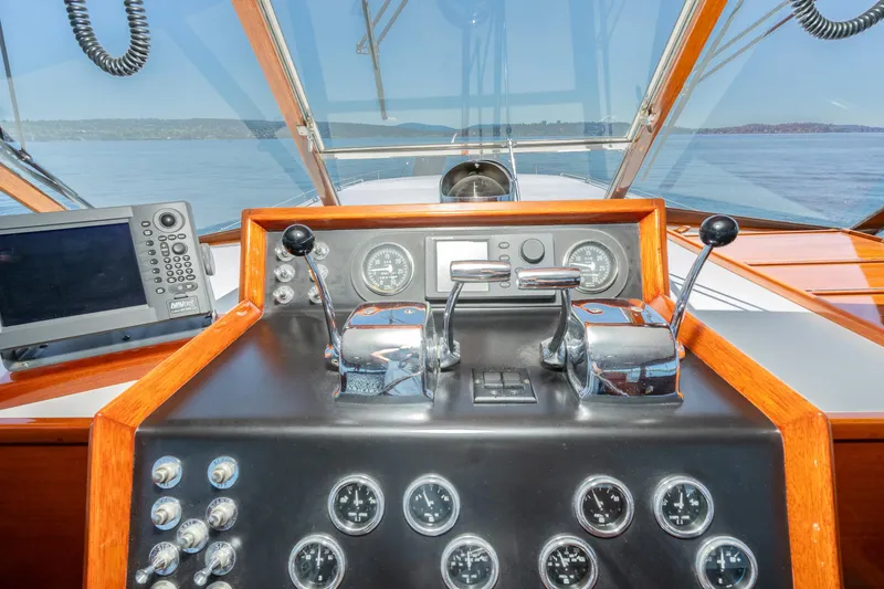 Slide: The Image of Helm of 1965 Chris-Craft 57 Constellation with gauges and controls, overlooking calm waters. - 15