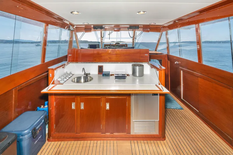 Slide: The Image of 1965 Chris-Craft 57 Constellation yacht interior with wooden cabinetry and ocean view. - 17
