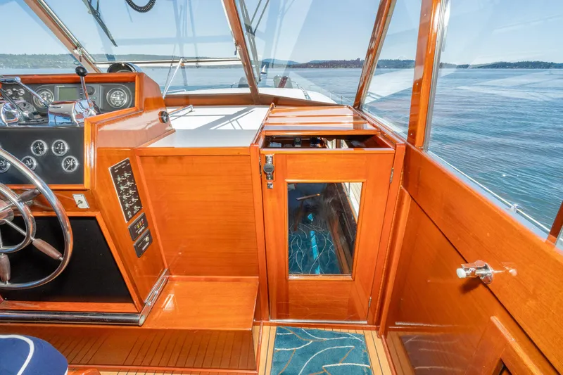 Slide: The Image of 1965 Chris-Craft 57 Constellation yacht interior with wooden finish and ocean view. - 21